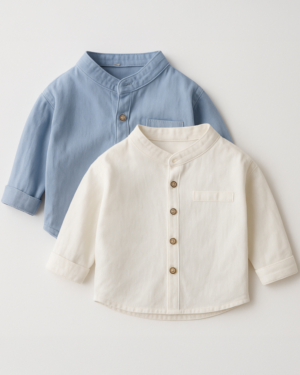 Duas camisas infantis com gola padre, uma bege e uma azul, com botões frontais, estilo elegante e confortável.